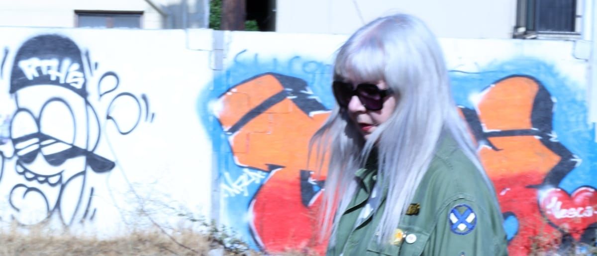 Silvia Ryder of My Violence walks in front of a heavily graffiti-ed wall - Photo by Dylan Luster