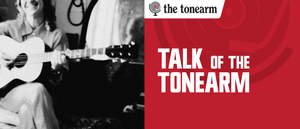 Sophie Wellington smiles while playing acoustic guitar in a grainy black-and-white photo, beside a red panel reading TALK OF THE TONEARM with The Tonearm logo.