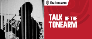 Grainy black-and-white silhouette of a man in profile, seen through vertical blinds, beside a red panel reading “Talk of the Tonearm” under the Tonearm logo.