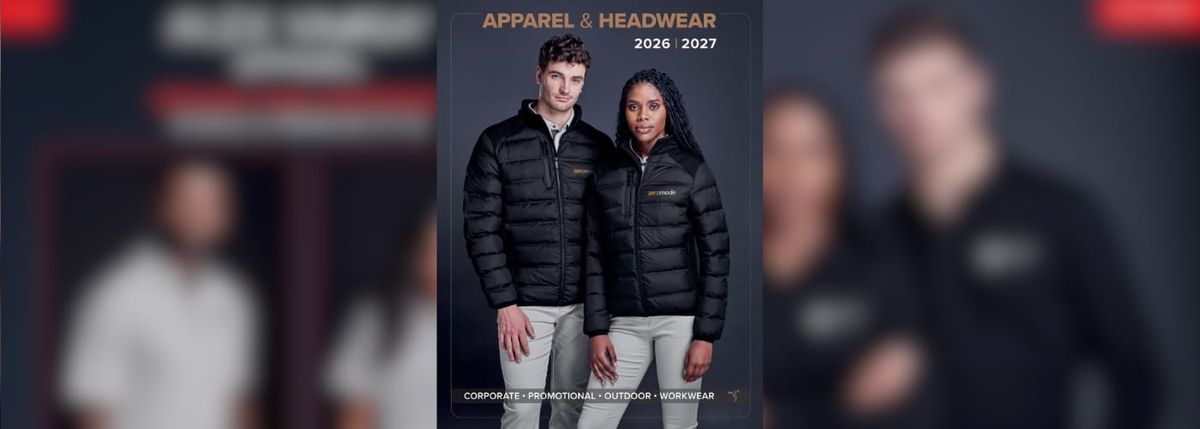 Two models, one male and one female, wearing black jackets stand against a dark background.