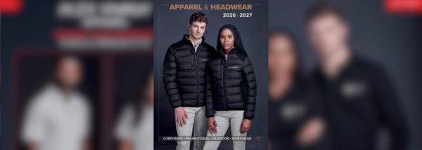 Two models, one male and one female, wearing black jackets stand against a dark background.