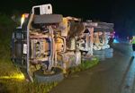 Dump truck overturns after striking power lines