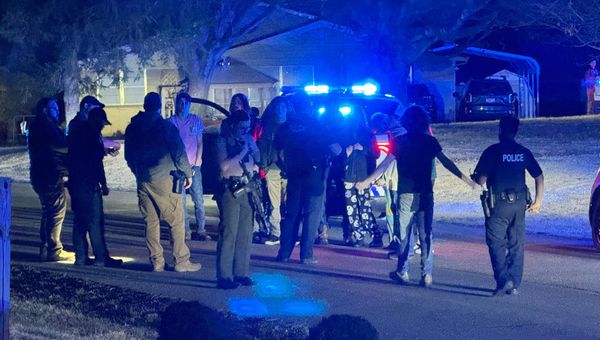 Lawmen swarm local house