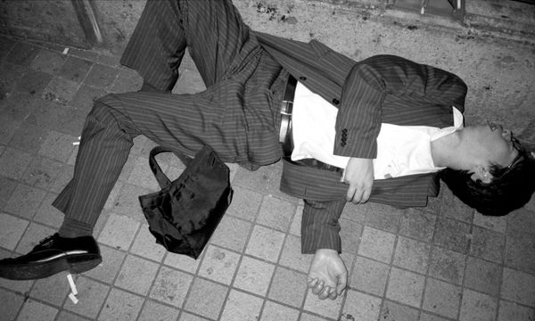 A Tokyo salaryman passed out drunk. Photo from High Fashion by Pawel Jaszczuk