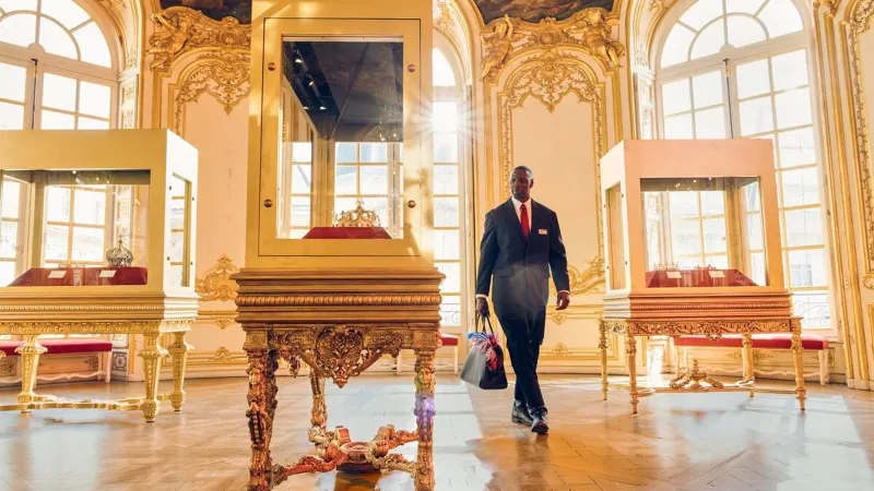 Omar Sy as Assane Diop walking through a gilded museum gallery in Lupin Part 4