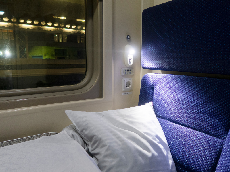 Cabin on a sleeper train with pillows and nightlight