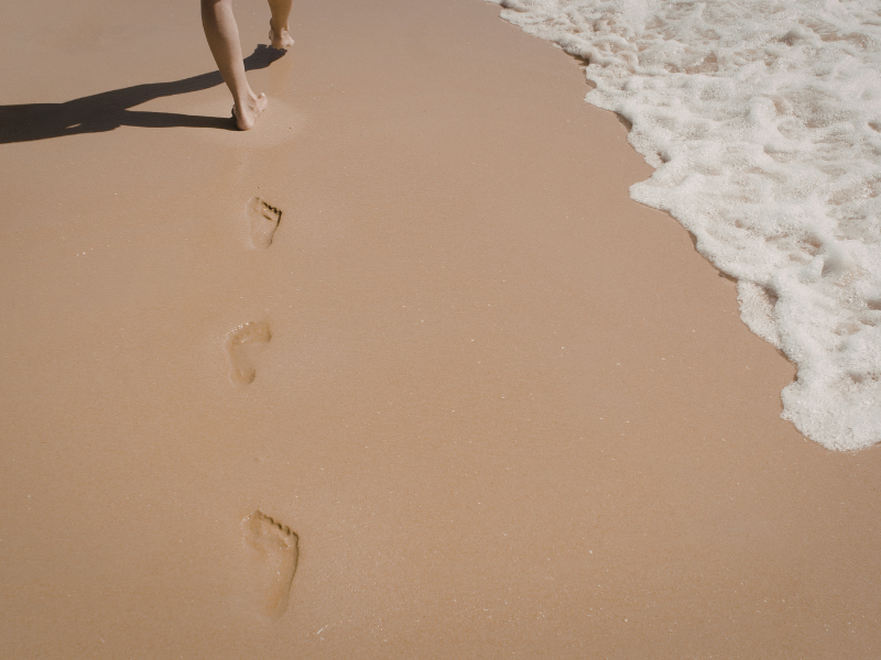 One set of footprints along a beach