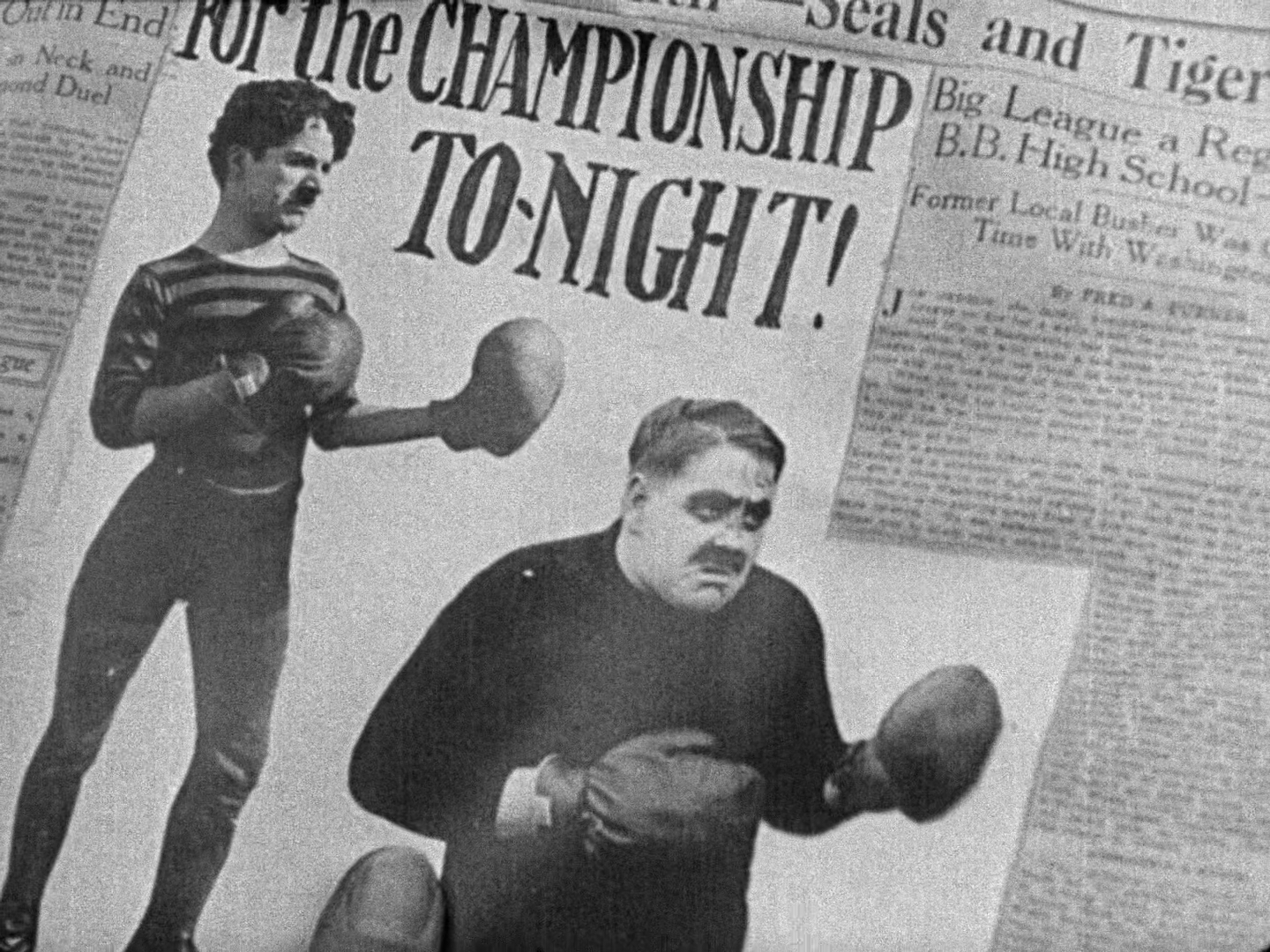 An in-movie newspaper clipping of Chaplin and his opponent, the headline says "For the CHAMPIONSHIP TO-NIGHT!"