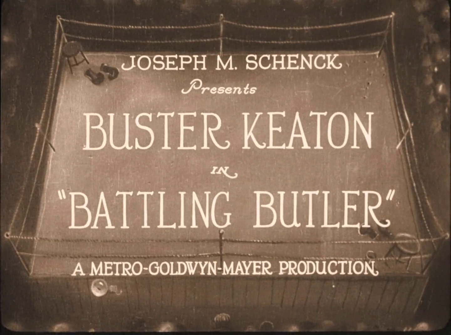 A very nice title card drawing of a boxing ring, the text says: JOSEPH M. SCHENCK Presents BUSTER KEATON IN "BATTLING BUTLER" A METRO-GOLDWYN-MAYER PRODUCTION