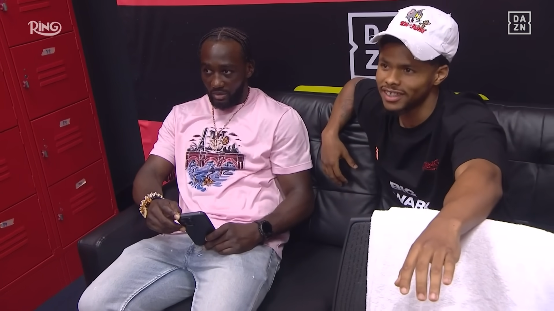 Shakur Stevenson wearing a hat with Tom & Jerry on it, he's sat next to Terence 'Bud' Crawford