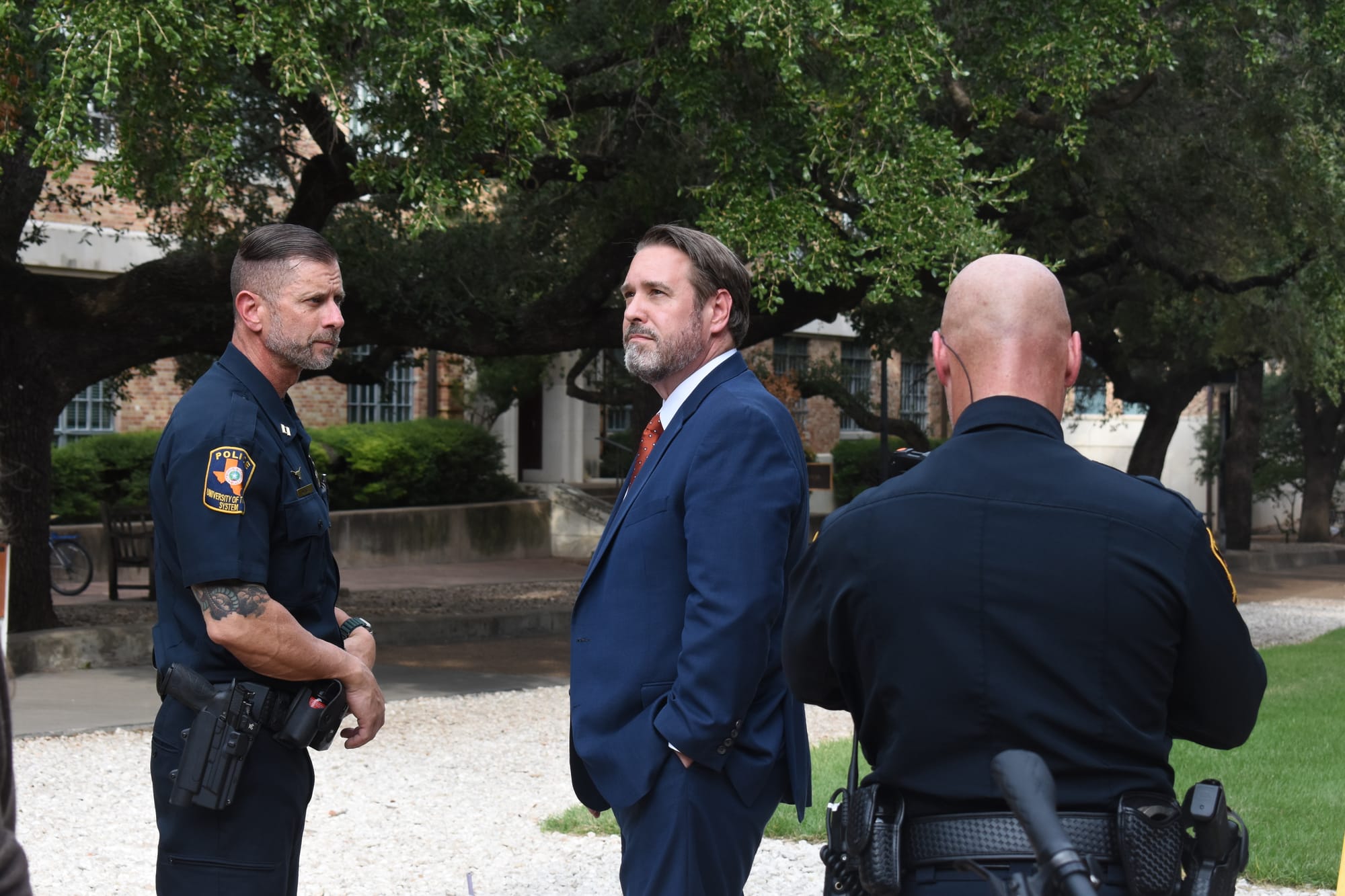 University of Texas President Jim Davis surveys the police presence outside of Hasan Piker’s speech at UT. Credit: Jackson Bauer