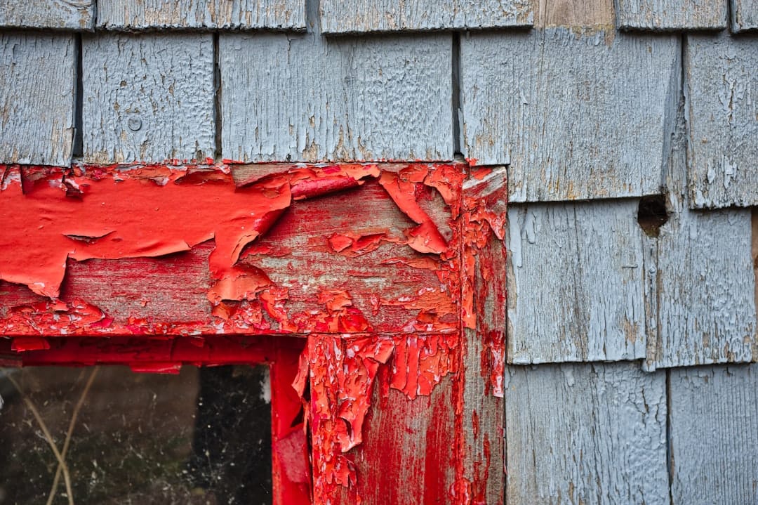 Boarded-up fire-damaged home with restoration work underway
