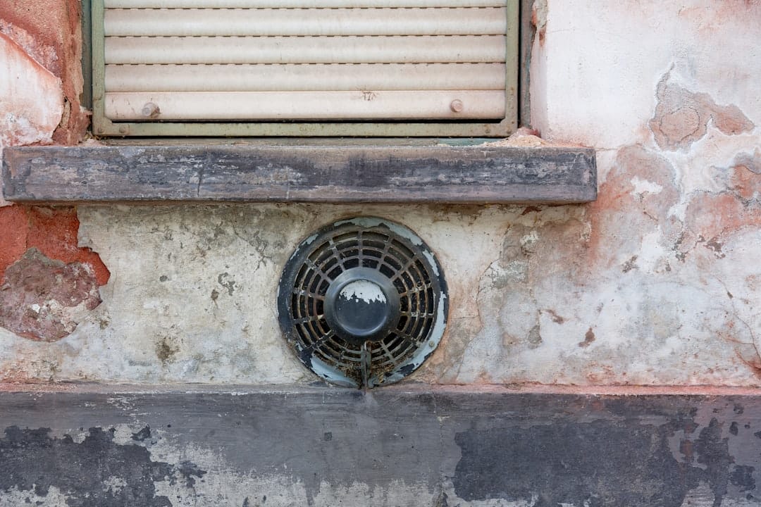 A technician servicing an AC unit during a Florida rental make-ready