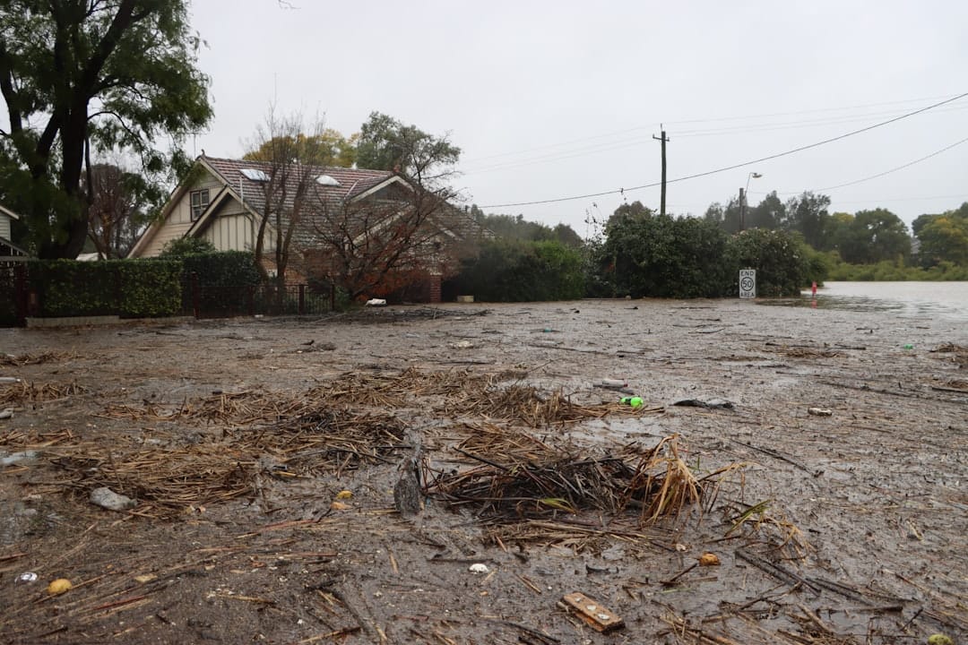 Floodwater standing in a residential neighborhood street after heavy rain