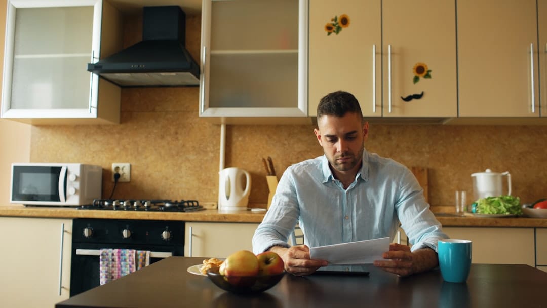A landlord and tenant reviewing a lease document together at a table