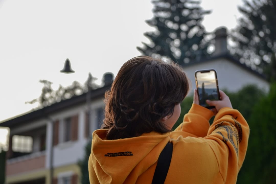 Owner photographing storm damage at a rental property