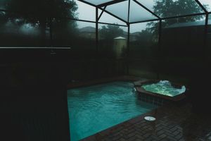 Screened-in backyard pool at a Florida home on a bright day