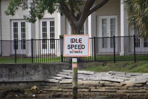 a sign on a pole in front of a building