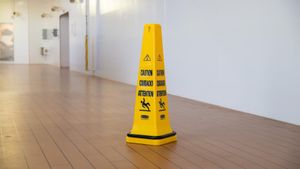 Wet floor caution sign in an apartment hallway