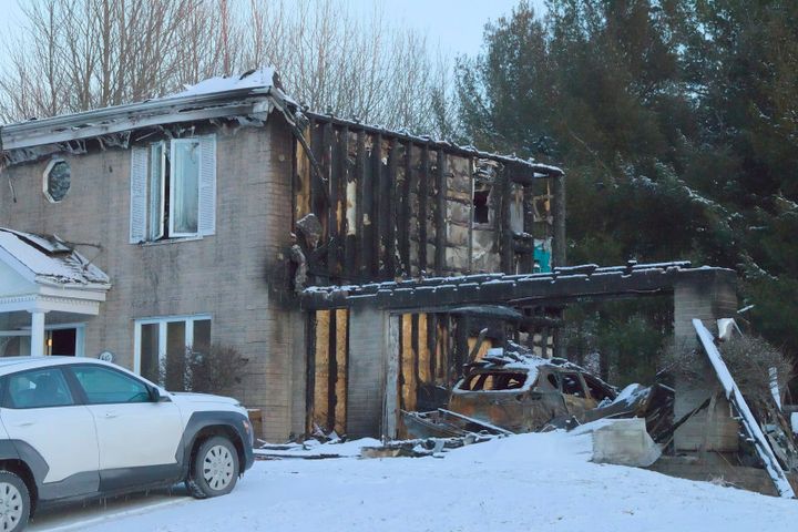 Fire-damaged single-family home exterior awaiting restoration