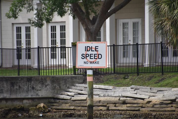 a sign on a pole in front of a building