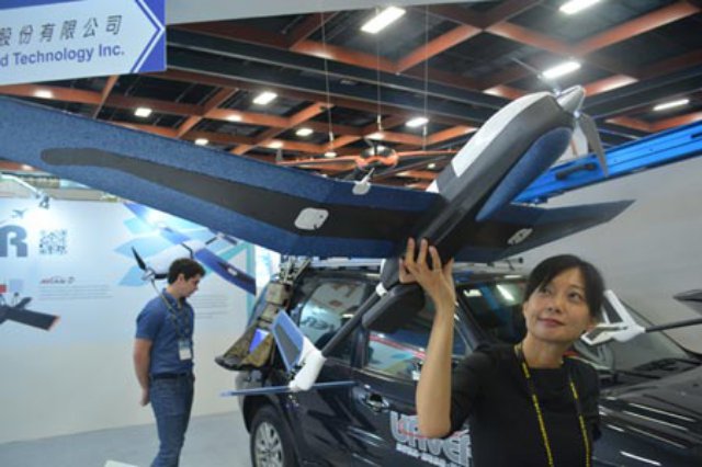 Cindy Chu, a representative of UAVER, demonstrates the Besra hand-launched drone to visitors at the Taipei Aerospace and Defense Exhibition