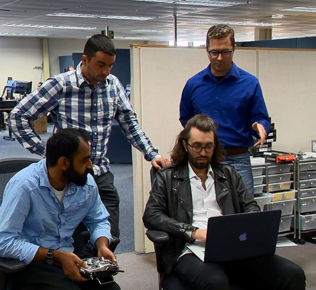 Naval Air Warfare Center Weapons Division Urban Reconnaissance and Situational Awareness teammates, from left, Shivneil Prasad, Georgi Ivanov, Christopher Gudea and Michael McConnehey test out the capabilities of the software and controller they used for their Innovation Challenge on Oct. 19 at Point Mugu, Calif.