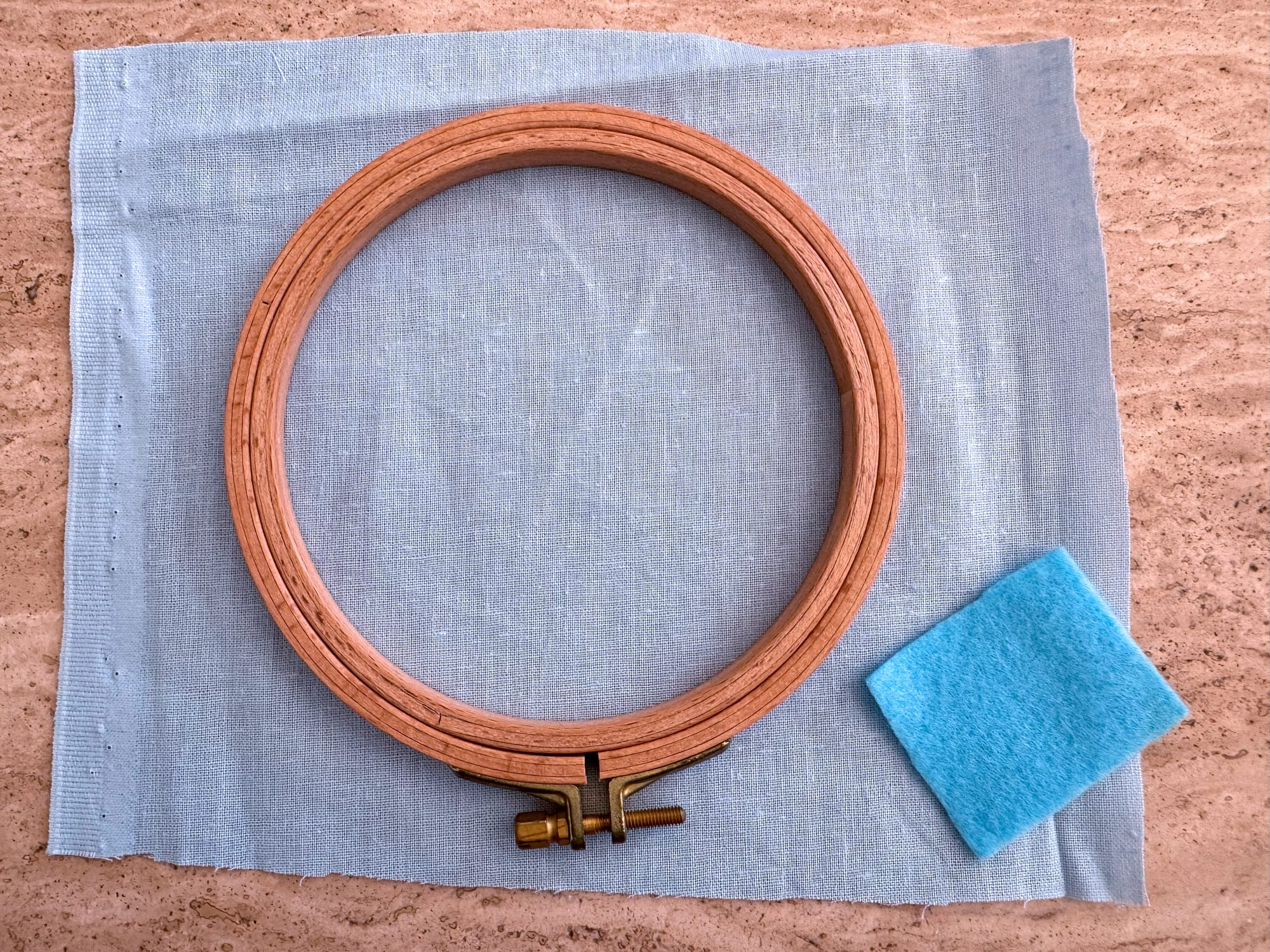 Materials: a piece of linen fabric, a small piece of felt, embroidery hoops