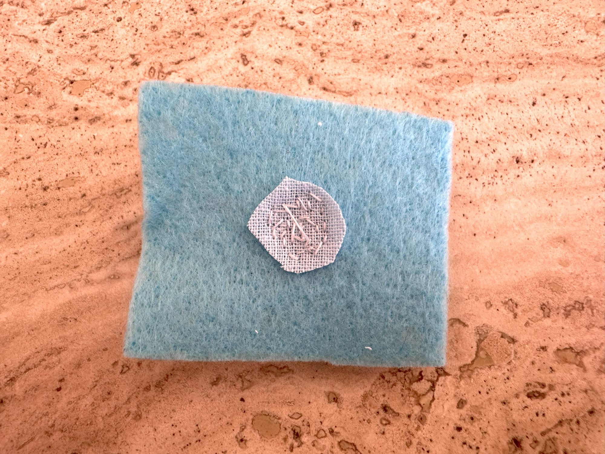 A piece of felt with 3D-beaded composition. Wrong side