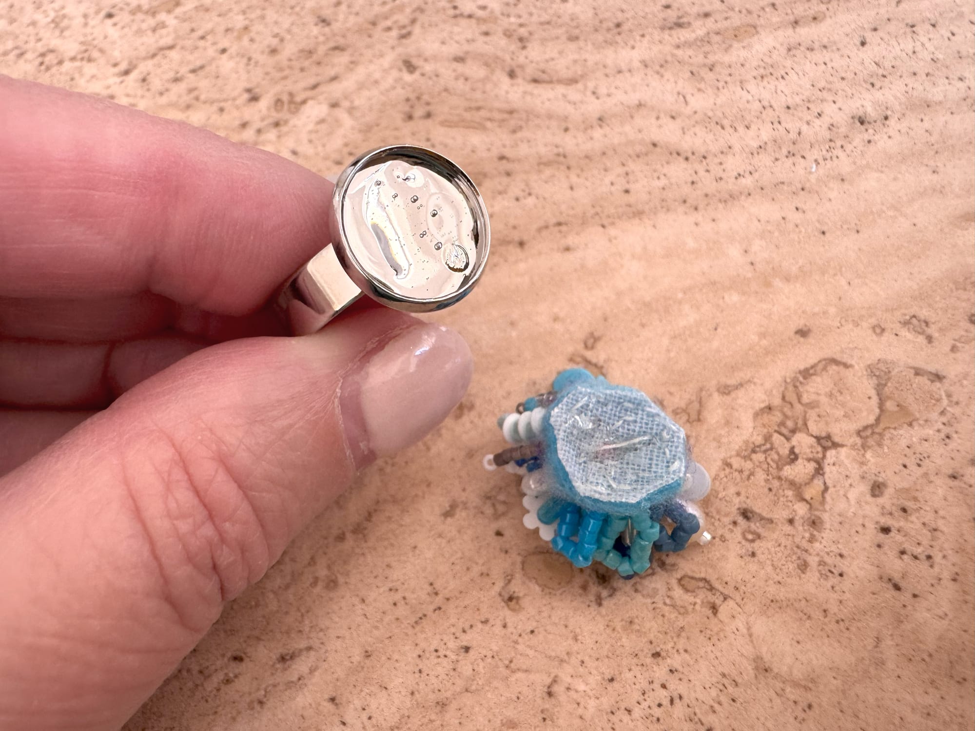 The ring setting with jewelry glue applied to the central part