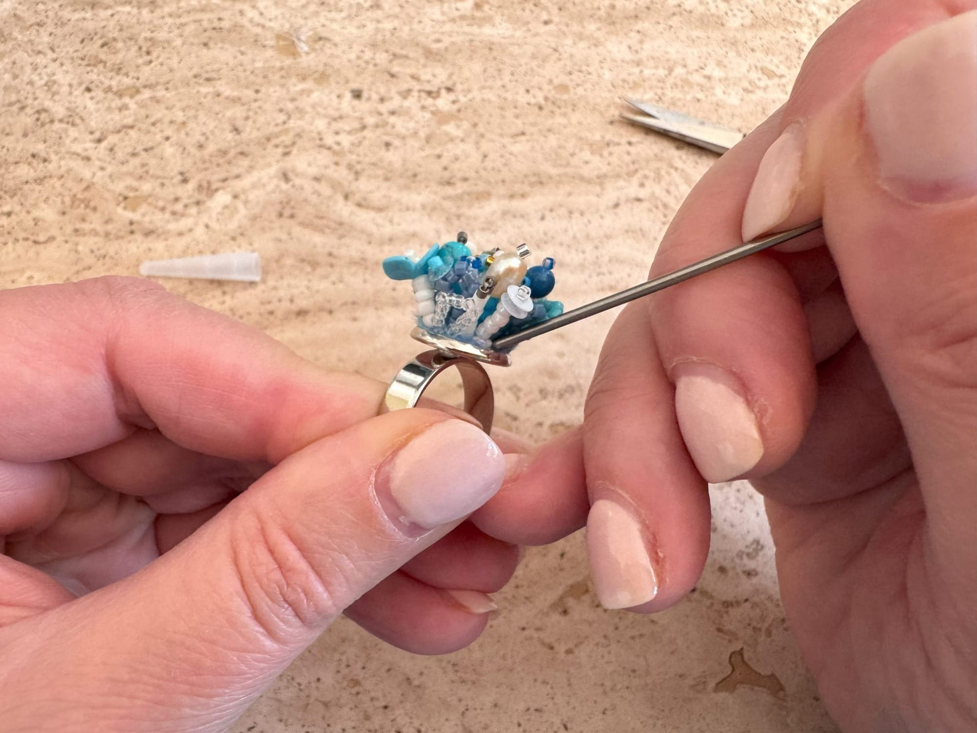 Inserting the felt into the ring setting using an awl