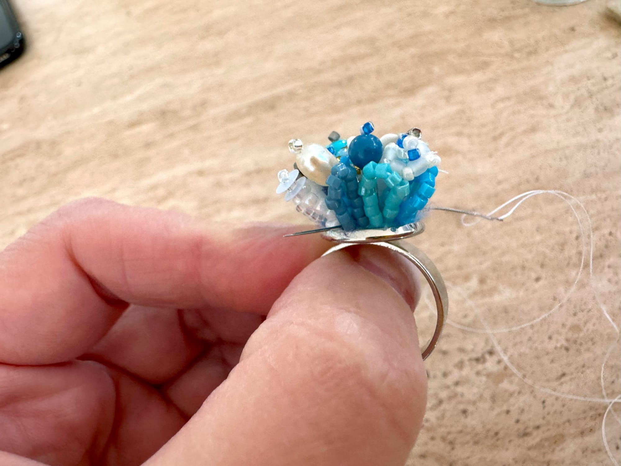 The needle existing at the very edge of the ring setting