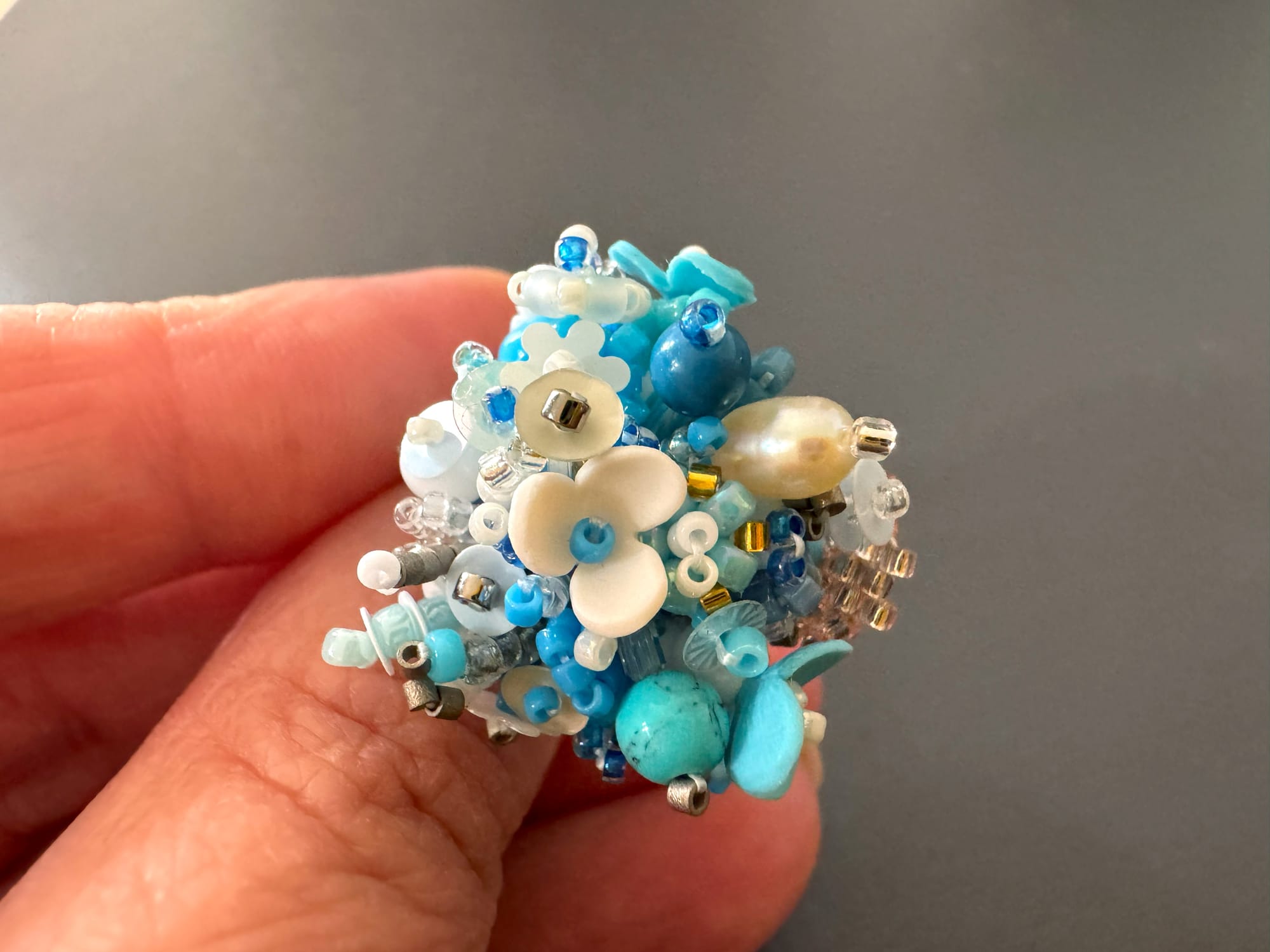 The 3D-beaded floral ring is made from Toho and Miyuki Delica beads, sequins, and stones