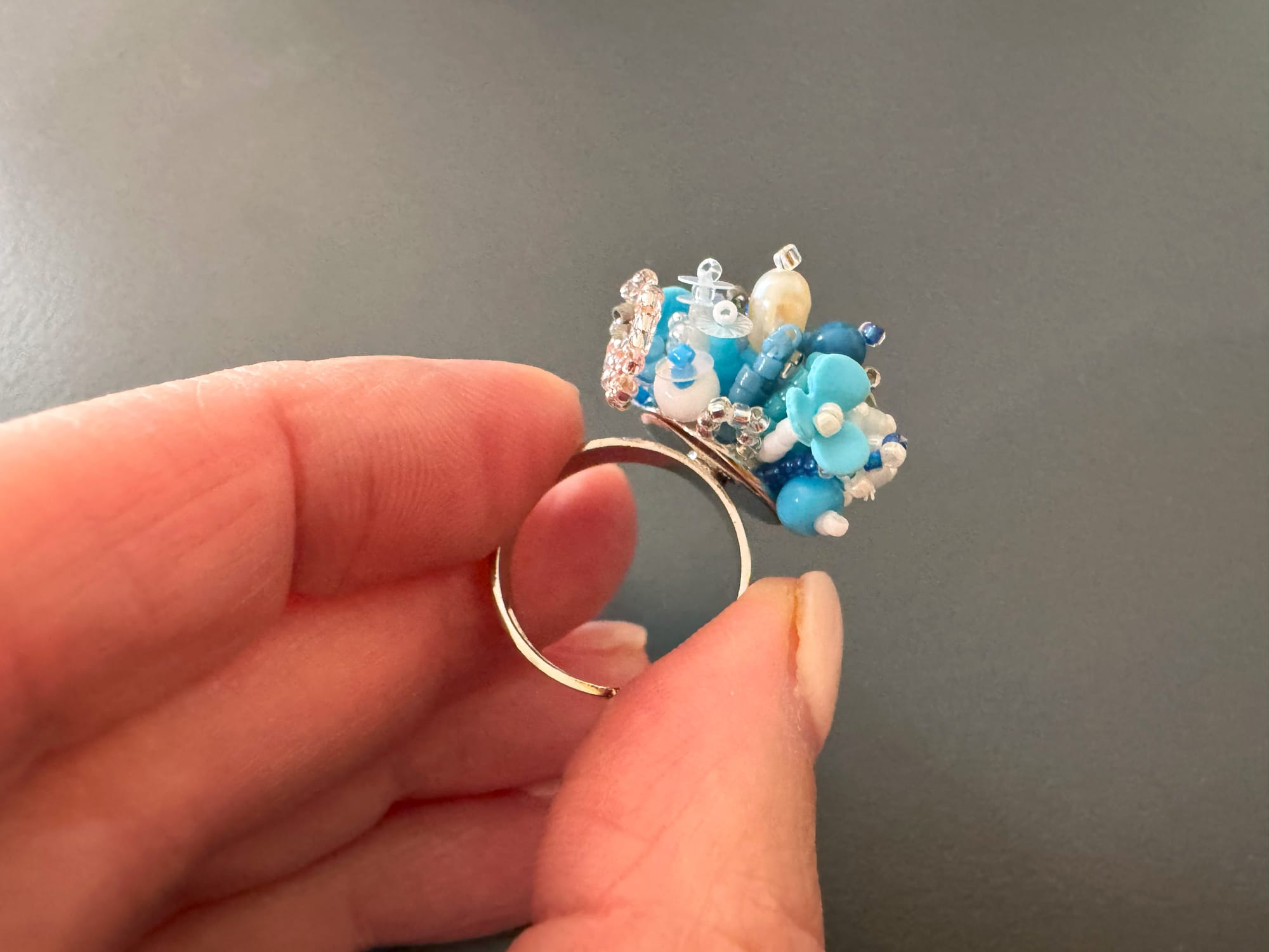 The 3D-beaded floral ring is made from Toho and Miyuki Delica beads, sequins, and stones