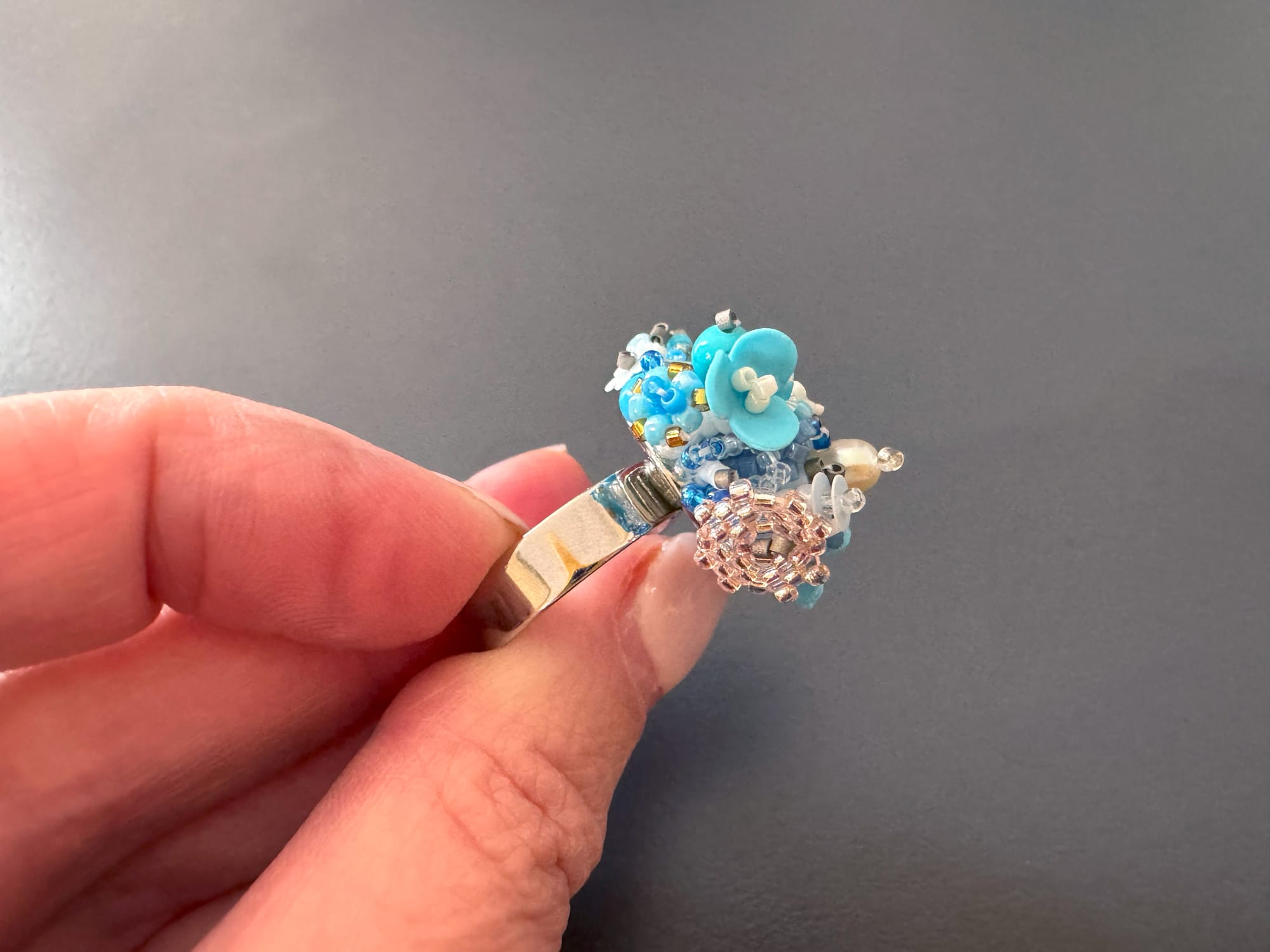 The 3D-beaded floral ring is made from Toho and Miyuki Delica beads, sequins, and stones
