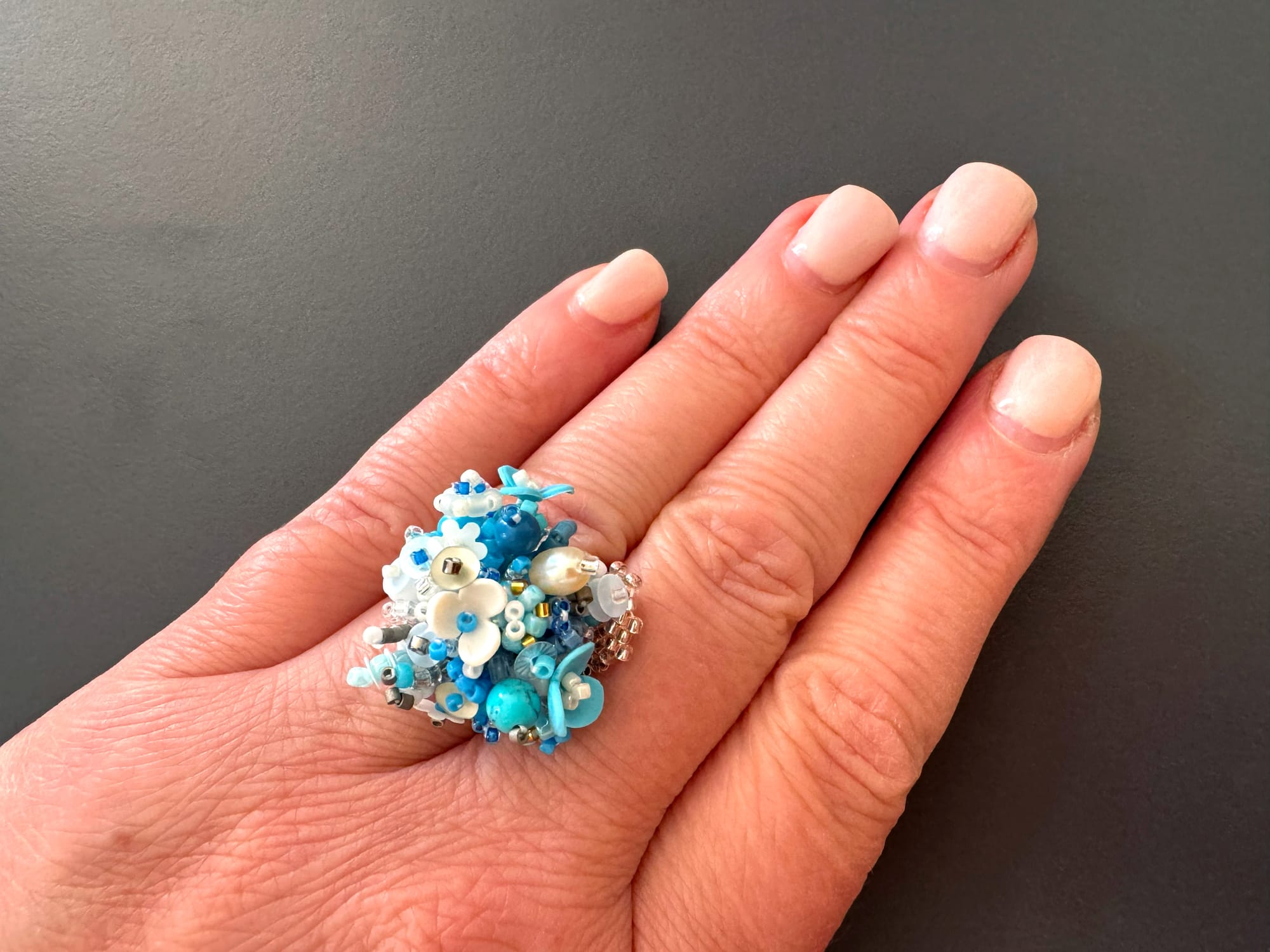 The 3D-beaded floral ring is made from Toho and Miyuki Delica beads, sequins, and stones