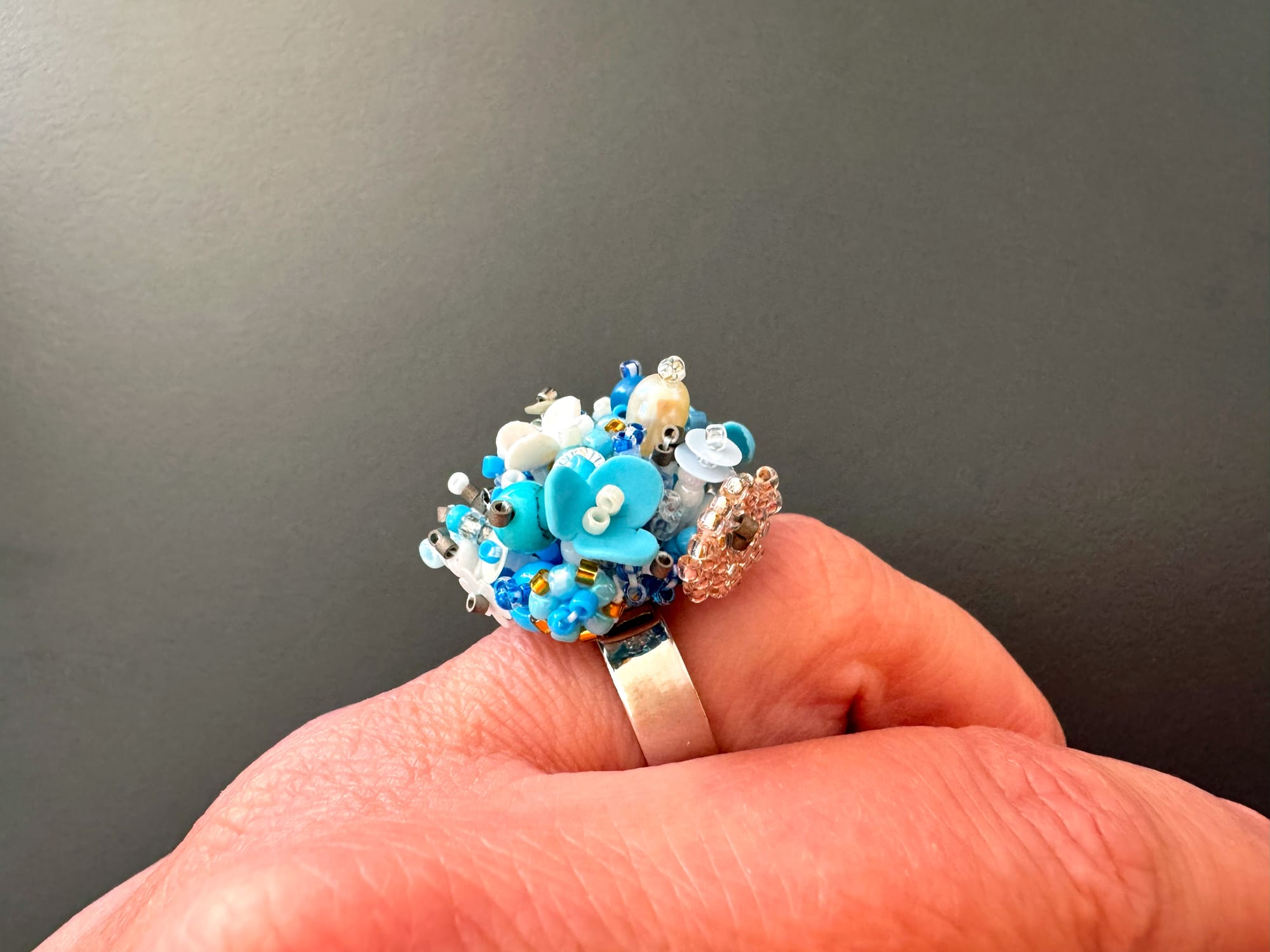 Sculpturally beaded floral ring from various beads and sequins