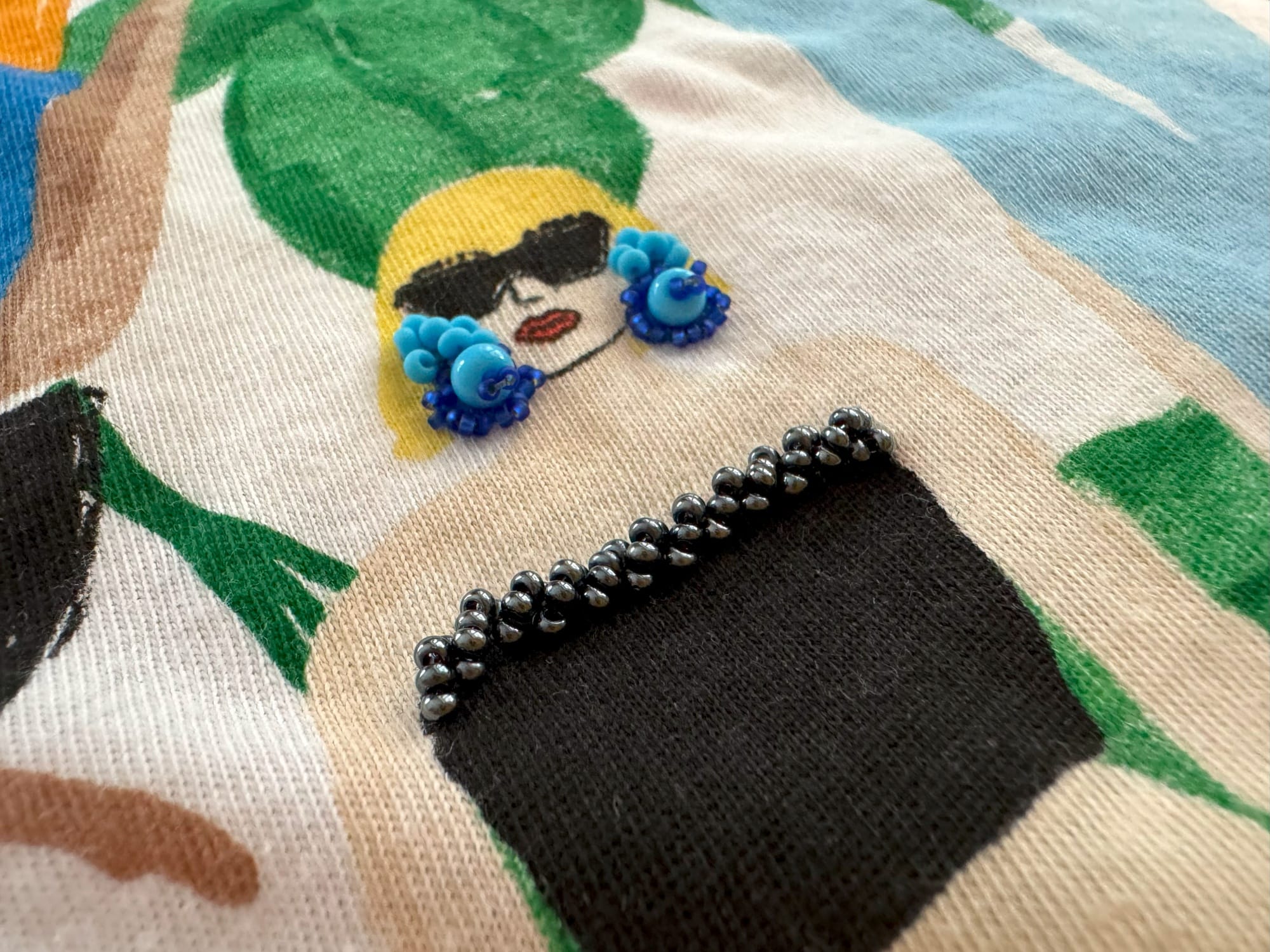 Lady with embroidered earrings and the top of the blouse decorated with beads