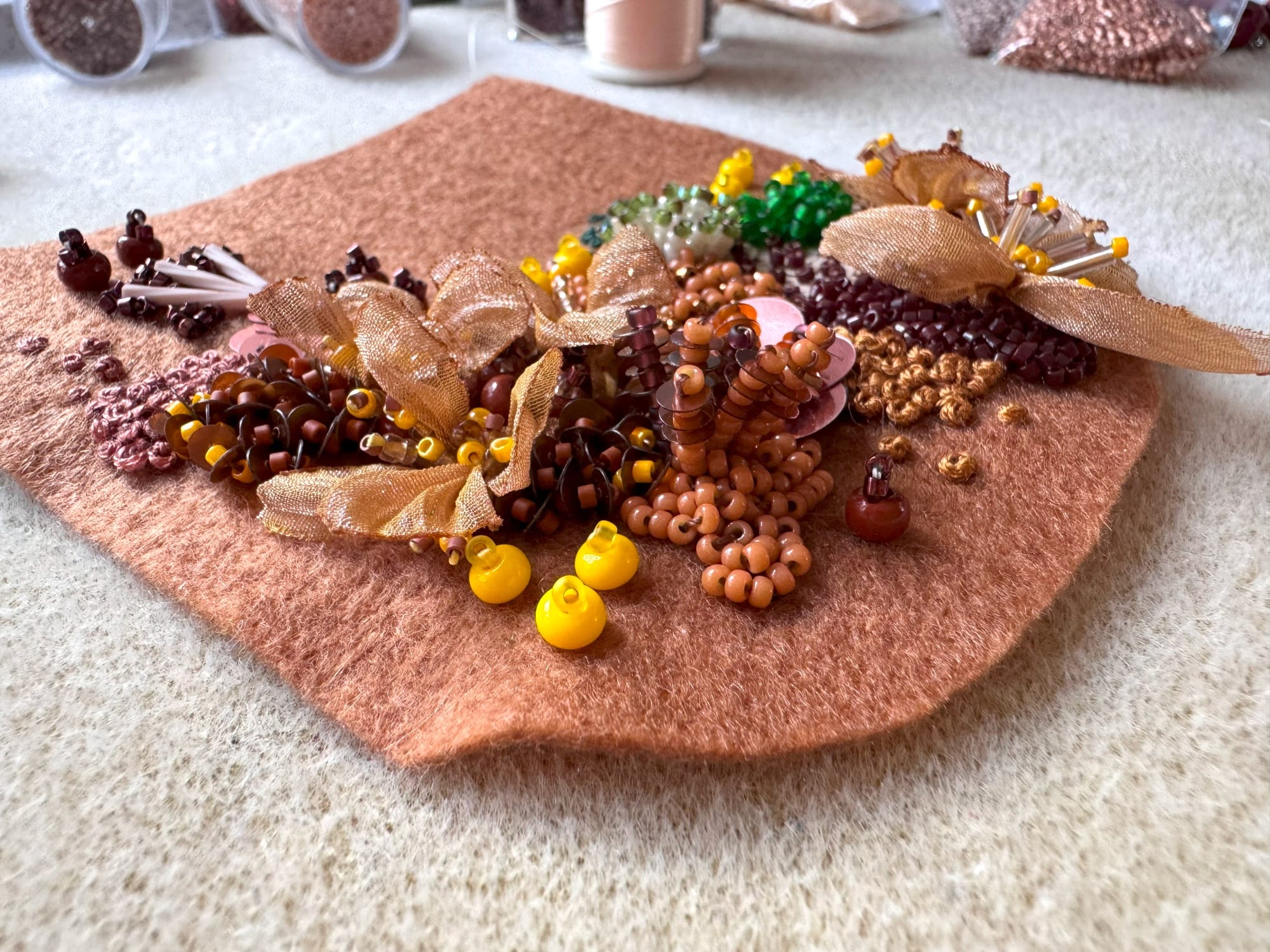 The felt detail is embellished with embroidery, beads, and sequins