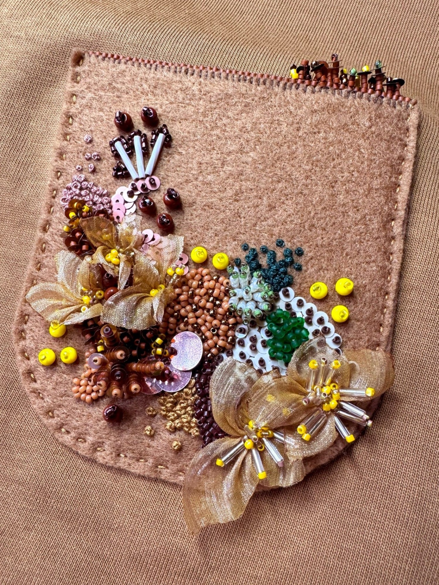 Embroidered pocket stitched to the blouse