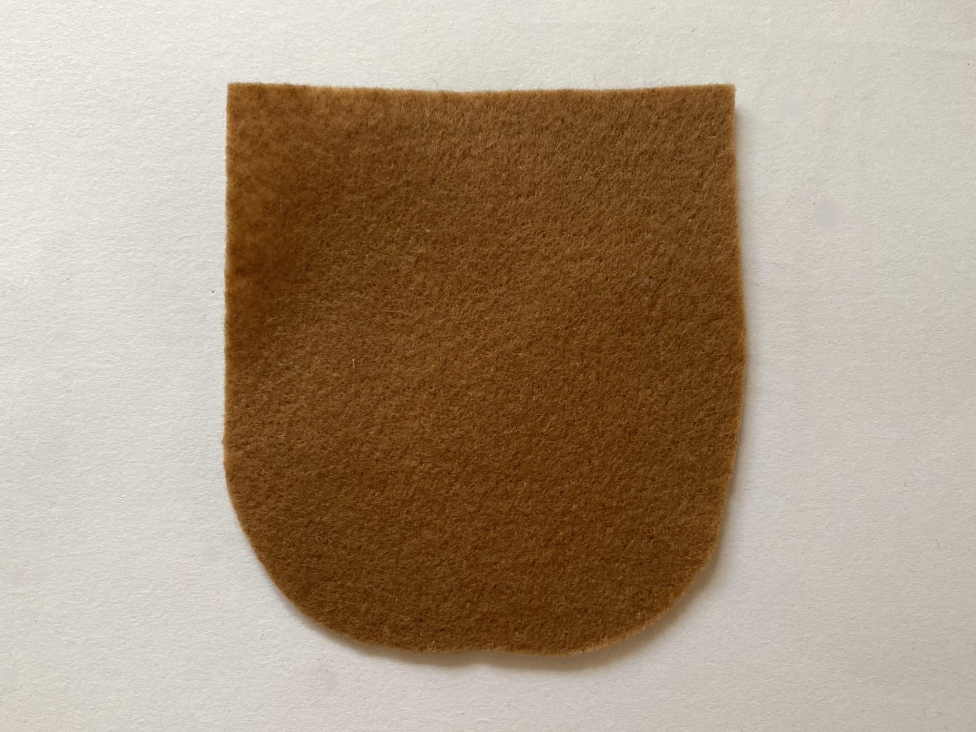 A pocket cut from the felt of the matching brown color.