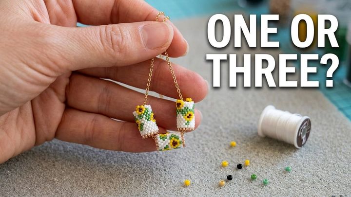 Three small sunflower-patterned Miyuki bead tubes hanging from a gold chain, with the words One or Three?