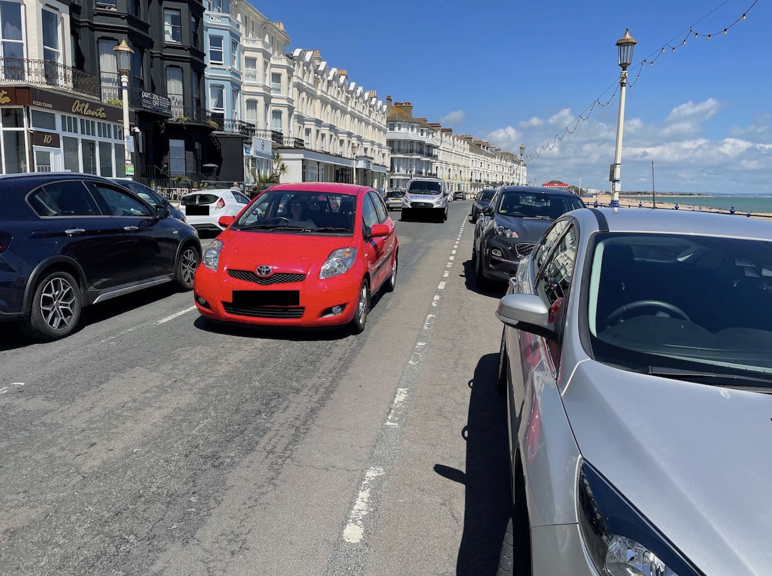 Marine Parade, Eastbourne, with parked cars and heavy traffic