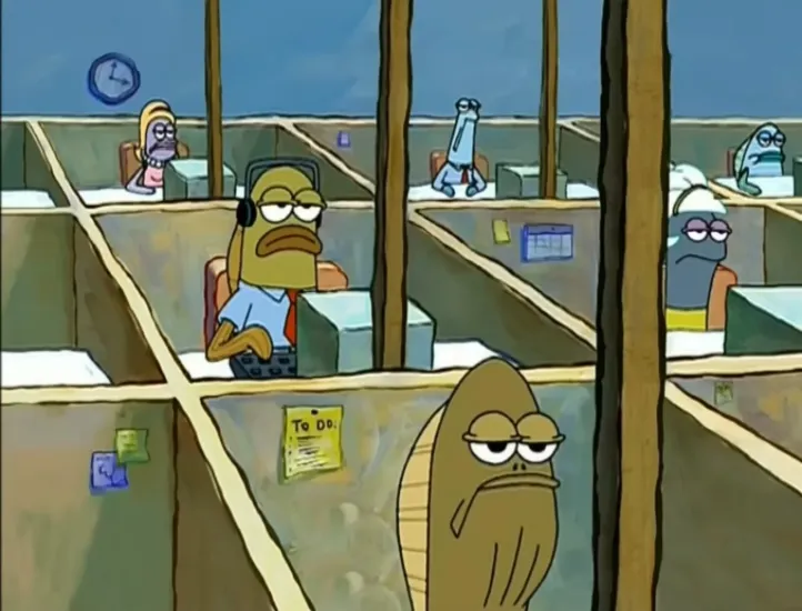 A still from an episode of Spongbob. Fish characters sit in a partitioned office, looking miserable.