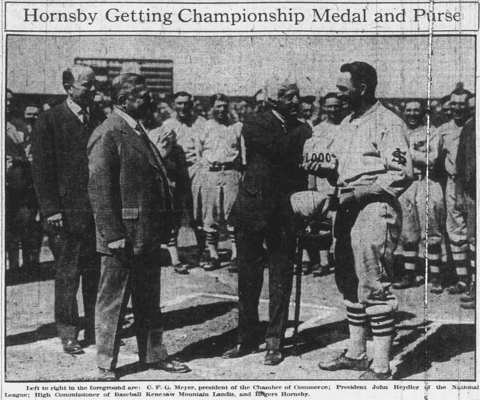 1926 newspaper photo showing Rogers Hornsby receiving his National League MVP medal and purse from John Heydler and Commissioner Kenesaw Mountain Landis before a St. Louis Cardinals game at Sportsmans Park.