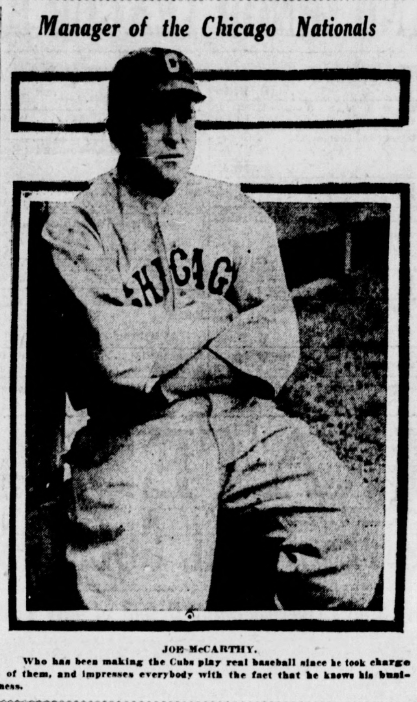 Black-and-white newspaper photograph of Chicago Cubs manager Joe McCarthy seated in uniform with arms crossed, featured in a 1926 newspaper profile discussing his early success managing the Cubs.