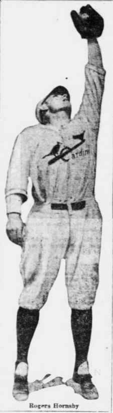 Full-length newspaper image of Rogers Hornsby reaching overhead with his glove while wearing a St. Louis Cardinals uniform.