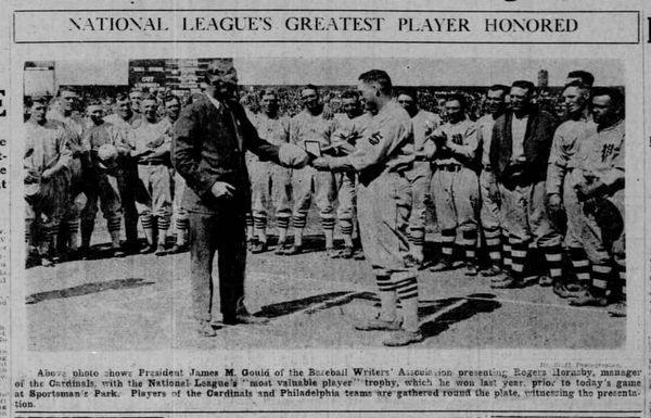 Rogers Hornsby accepts the 1925 National League MVP trophy at Sportsman’s Park in St. Louis on May 22, 1926, surrounded by Cardinals and Phillies players during the Hornsby Day celebration.