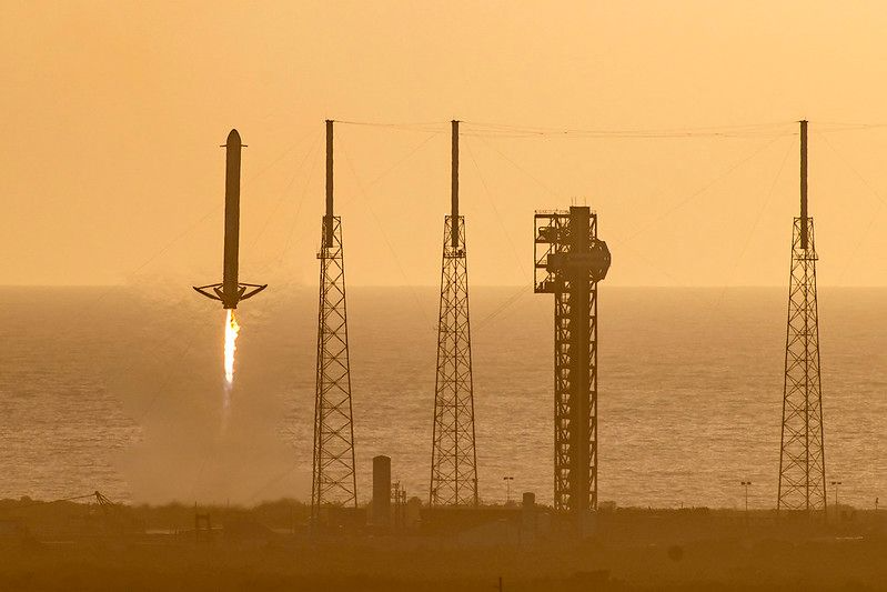 One of SpaceX’s Falcon Heavy side boosters that launched NASA’s Nancy Grace Roman Space Telescope returns to land at Landing Zone 40. The three 600-foot catenary-wire towers can be seen on Pad 39B in the background. (NASA photo)