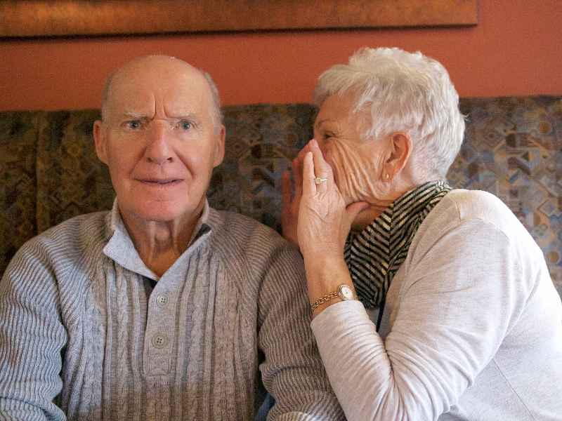 An elderly couple struggling to communicate with each other due to dementia.